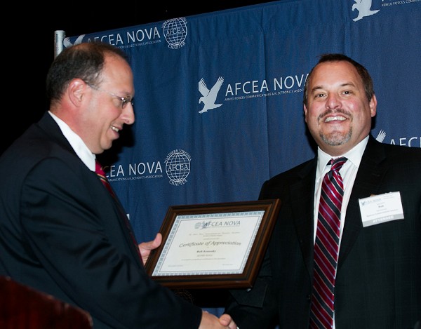 Chris Cusano (l), chapter president, presents the November SuperNOVA Award to Rob Konosky, Raytheon Trusted Computing Systems.